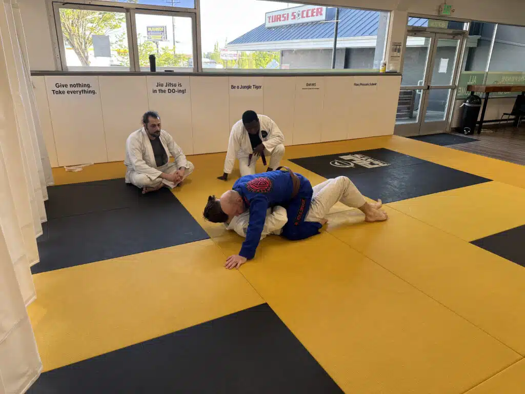 Adults practicing an escape during self defense classes in Portland at Five Rings Jiu Jitsu Portland