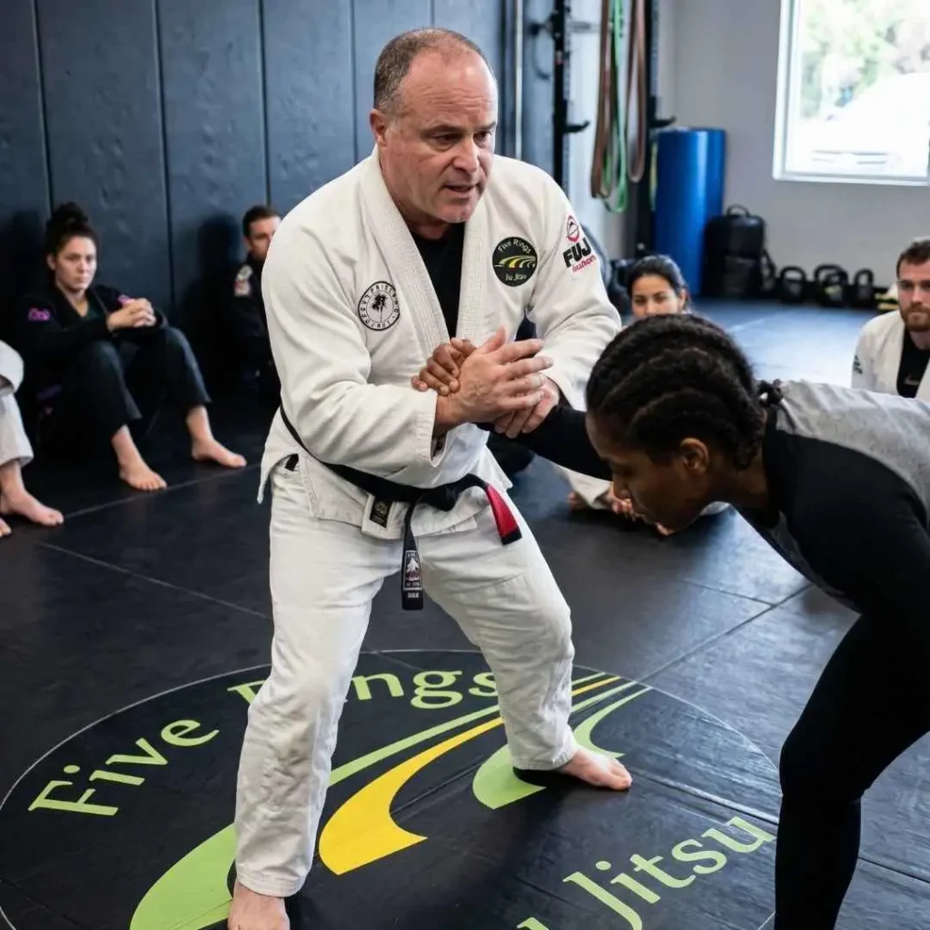 an instructor demonstrating a self-defense move.