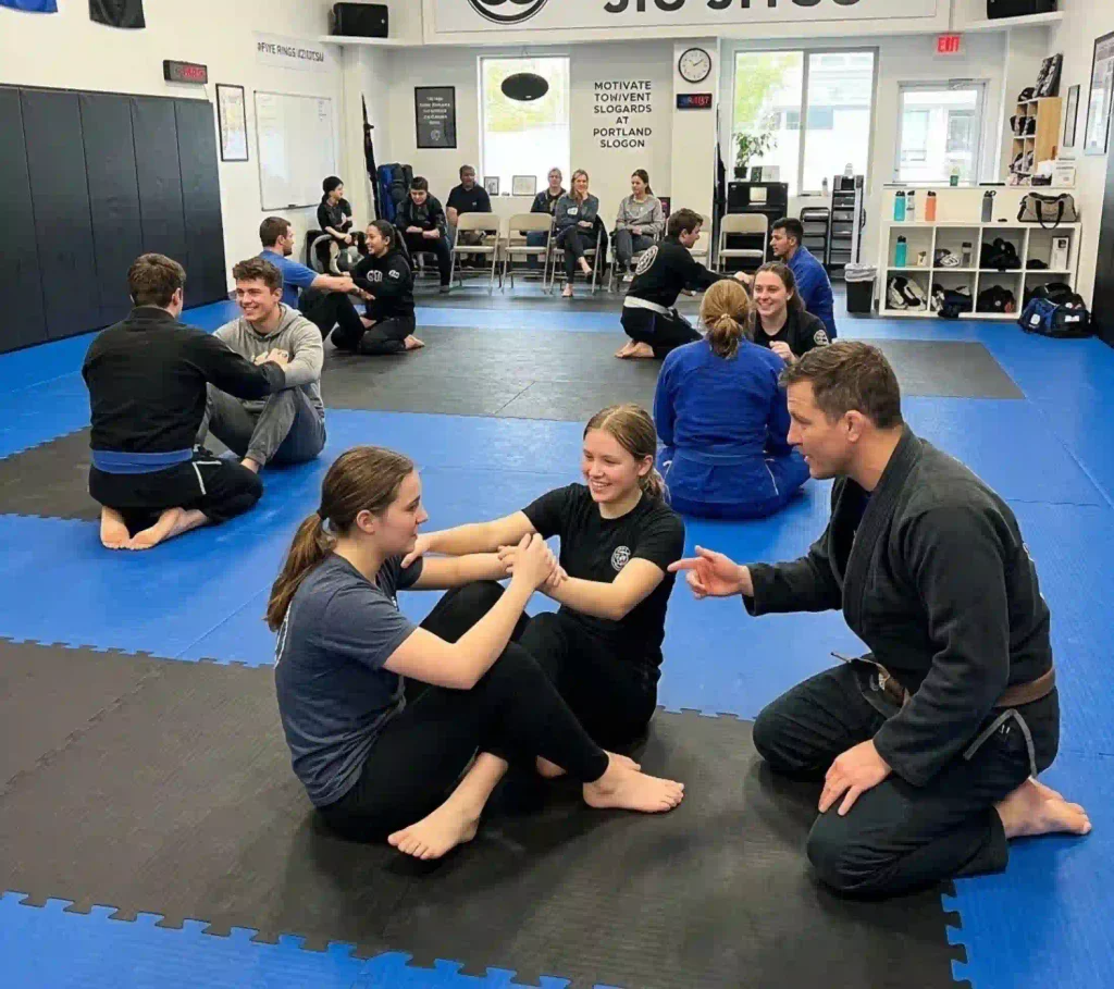 College students practicing self defense at Five Rings Jiu Jitsu Portland